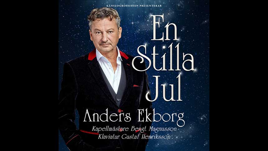 Anders Ekborg i mörk kostym och vit skjorta, mot blå bakgrund. Promotionbild.